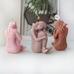 three ceramic figurines sitting next to each other