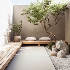 an outdoor area with rocks, gravel and a tree