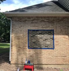 a brick building with a blue window on the side