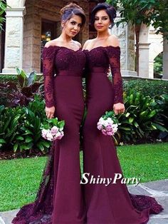 two women in long dresses standing next to each other on the same page, one is holding