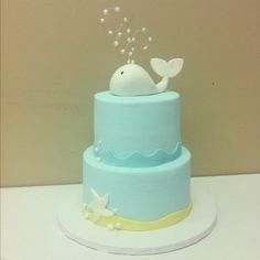 a blue and yellow cake with a whale on top