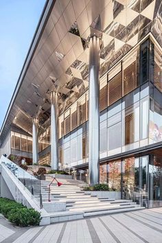 a large building with stairs leading up to it's entrance and windows on the side