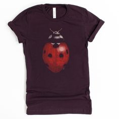 Did you know that one ladybug can eat up to 5,000 insects in its lifetime? Luckily, this shirt doesn't eat insects, or anything at all! Show your love for these cute beetles without the worry of losing it in the house. -------------- Every item sold plants 1 tree- Eco-Friendly shirts-------------- 100% combed and ring-spun cotton (heather colors contain polyester)- Soft, stretchy material--not heavy or rigid- Fabric weight: 4.2 oz (142 g/m2)- Shoulder-to-shoulder taping- Side-seamed------------- Pretty T Shirts, Ladybug Clothes, Indie Shirts, Bug Clothes, Ladybug Shirt, Shirts To Buy, Bug Shirt, Bug Clothing, Silly Clothes