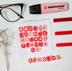 a pair of glasses sitting on top of a white table next to some stickers