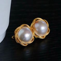 --- SPECIFICS --- 💚Materials: 100% Natural High Quality Mabe Pearl With 24k gold plated s925 Sterling silver 💚-The Mabe Pearl is 100% natural UNTREATED , UNHEATED, UNDYED Mabe Pearl- 💚Metal: Real 24k Gold plated s925 Sterling Silver 💚Pearl Diameter: 17mm*17mm 💚Closure: the closure is made of 925 Sterling Silver.  💚Handmade Artwork, original design and copyright protected💚 These stunning gold plated silver earrings feature a beautiful pair of hemisphere Mabe Pearl stones. With their intricate details and rich color, these push back studs are the perfect statement piece for any outfit. Handcrafted with care, these earrings are a true work of art and are sure to draw attention wherever you go. Whether you're looking for a unique gift or simply want to treat yourself. With their durable Elegant Pearl White Clip-on Earrings, Fine Jewelry Clip-on Earrings For Wedding, Handmade Rose Gold Elegant Bridal Earrings, Handmade Elegant Rose Gold Bridal Earrings, Elegant Rose Gold Clip-on Jewelry, Handmade Elegant Round Pearl Earrings, Handmade Elegant Pearl Earrings, Elegant Handmade Round Pearl Earrings, Wedding Sterling Silver Clip-on Pearl Earrings