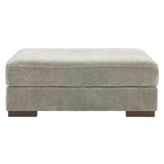 a grey ottoman with wooden legs on a white background