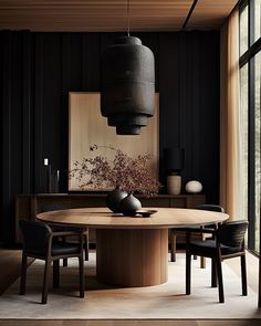 a dining room with black walls and wooden table surrounded by chairs, vases and artwork