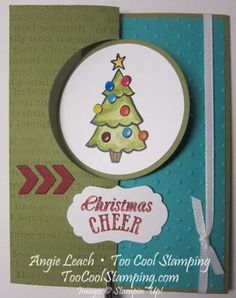 a handmade christmas card with a tree on the front, and an arrow at the bottom