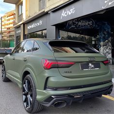 the rear end of an suv parked in front of a store