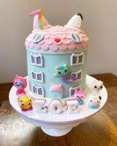 there is a cake that looks like a house with animals on the front and sides