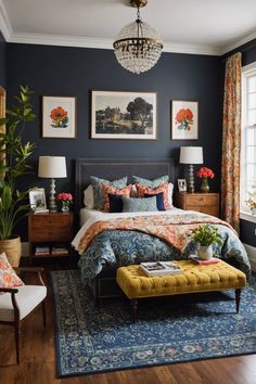 a bedroom decorated in blue and orange with pictures on the wall above the bed, along with a yellow footstool