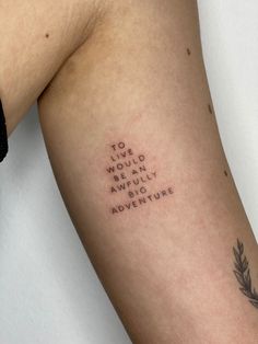 a person with a tattoo on their arm that says to the world be in awfully adventure