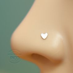 a close up of a nose with a small heart on it