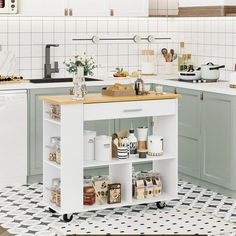 a small kitchen island in the middle of a tiled floor