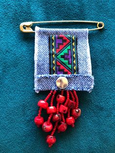 a piece of cloth with beads hanging from it's side on a blue towel