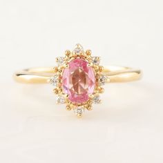 This is made to order ring. Beautiful unheated pink sapphire from Madagascar, weight ranges from 0.60 to 0.7ct, 7x5mm, eye clean 0.08ctw., G color SI clarity accent diamonds Band width: approx. 1.9mm High profile setting, easy stacking with a straight band Made of recycled solid 14k gold Our Dedication All our jewelry is designed and created by Kat with great attention to details and the entire production from casting, stone setting to finishing takes place in New York, USA. All gemstones used i Classic Pink Cluster Ring With Halo Setting, Pink Oval Cluster Ring Fine Jewelry, Pink Oval Cluster Ring With Center Stone, Pink Sapphire Promise Ring With Halo Design, Pink Oval Sapphire Ring With Halo Setting, Pink Oval Sapphire Promise Ring, Pink Oval Cluster Promise Ring, Pink Oval Diamond Ring With Halo Design, Pink Oval Halo Ring For Anniversary