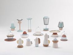 a group of ceramic objects sitting on top of a white table next to each other