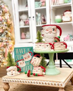 santa clause cupcakes on a cake stand in front of a christmas tree