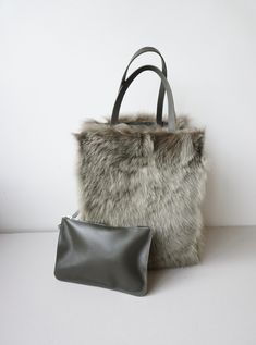 "Shearling tote looks good and feels even better..in colder months..soft, cute and cuddly.. You can wear it in two ways-with fur outside or if it is raining-with leather outside It's crafted to a relaxed shape that's suspended from narrow leather straps. Interior features a handy detachable leather pouch. With Clasp-fastening tab at open top possible to give to the bag different look and size Colour- khaki goat fur, khaki leather Measures approx: - Height : 36 cm / 14,7'' - Width:open top 55 cm Winter Sheepskin Rectangular Bag, Winter Rectangular Sheepskin Bags, Winter Bags With Plush Lining For Everyday Use, Winter Shoulder Bag With Plush Lining For Everyday Use, Winter Fluffy Rectangular Shoulder Bag, Fluffy Rectangular Shoulder Bag For Winter, Winter Faux Fur Rectangular Shoulder Bag, Winter Faux Fur Shoulder Bag With Plush Lining, Faux Fur Shoulder Bag For Shopping