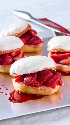 strawberry shortcakes with white frosting and strawberries