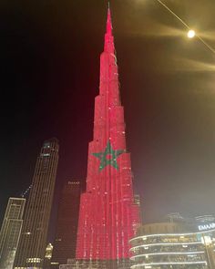 the burj building is lit up in red