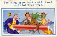 an old postcard features two men and a woman on the beach, one holding a large pipe