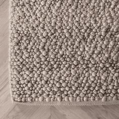 a white rug on top of a wooden floor