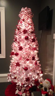 a white christmas tree decorated with candy canes