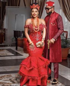 a man and woman dressed in red standing next to each other