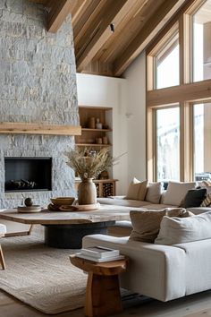 a living room filled with lots of furniture and a fire place in the middle of it