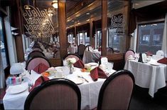 a restaurant with tables and chairs covered in white tablecloths