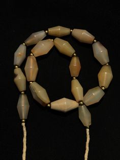 A beautiful string of Bended white agate natural found from Afghanistan dating 1800 yrs. They are found at that time in Afghanistan mostly but also some found in India and Pakistan too. They were used as a special charm jewellery by the affluents at that time period. Beautiful counter bronze are decorated further in between the beads. Luxury Vintage Agate Beads, Carnelian Necklace, Crystal Bead Necklace, India And Pakistan, White Agate, Jade Necklace, Time Period, Agate Beads, Agate Stone