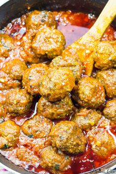 meatballs and sauce in a pan with a wooden spoon on the side, ready to be eaten