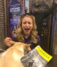 a woman is getting her hair cut by a dog