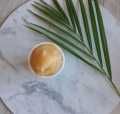 a table topped with a bowl of food and two green palm leaves on top of it