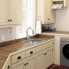 a kitchen with white cabinets and a dishwasher next to a stove top oven