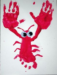 a red crab with googly eyes on it's face and hands painted in white paper