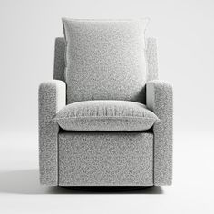 a gray chair with a pillow on it's back and seat cushion upholstered