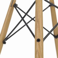 a close up of a wooden and metal stool