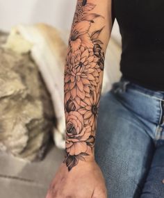 a woman's arm with flowers on it