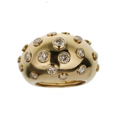 The Christian Dior Vintage Bombe Diamond 18k Yellow Gold Cocktail Ring is an exquisite piece that exemplifies the elegance and luxury synonymous with the Dior brand. This stunning cocktail ring is a perfect blend of classic design and sophisticated glamour, making it a must-have for any jewelry connoisseur. Crafted from 18k yellow gold, this ring features a bold and distinctive bombe design. The bombe style, characterized by its rounded, dome-like shape, creates a striking silhouette that is both eye-catching and timeless. The warm, rich hue of the yellow gold adds a touch of opulence, enhancing the overall allure of the piece. The surface of the ring is adorned with numerous bezel-set diamonds, each meticulously chosen for its brilliance and clarity. These diamonds are strategically place Dior Brand, Victoire De Castellane, Delicate Engagement Ring, Yellow Gold Cocktail Ring, Dior Vintage, Dior Jewelry, Gold Cocktail Ring, Gold Cocktail, Bezel Set Diamond