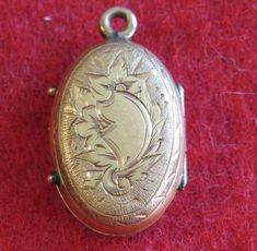 "An Awesome 1890's Victorian 14 Karat Yellow Gold Locket With Photos Necklace Pendant. Visit our shop for awesome retro photos, vintage jewelry, sports memorabilia and home decor. Size: 1/2\" across x 3/4\" high Material: 14 Karat Yellow Gold Condition: Good. Front Is Bowed In. Photos Show Wear. Year: 1890's Signed: Unsigned. Inventory #: 2280" Victorian Medallion Jewelry For Vintage Events, Vintage Brass Jewelry For Memorial, Vintage Hallmarked Antique Gold Jewelry, Vintage Antique Gold Hallmarked Jewelry, Vintage Antique Gold Jewelry Hallmarked, Vintage Hallmarked Jewelry For Vintage Events, Antique Finish Jewelry For Memorial, Antique Etched Gold Locket Necklace, Vintage Antique Gold Filigree Jewelry