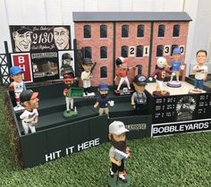 a group of baseball figurines sitting on top of a field