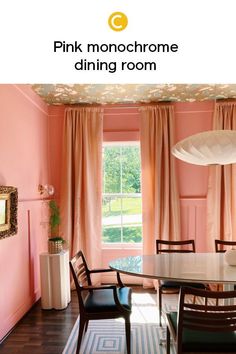 a dining room with pink walls and curtains