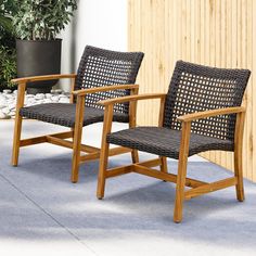 two wooden chairs sitting next to each other