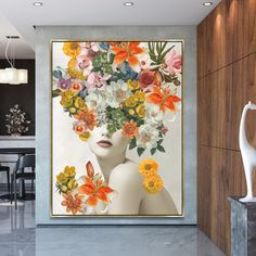 a woman with flowers in her hair is shown on the wall next to a vase