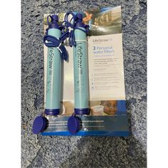 two water filters sitting on top of each other next to an advertiser's brochure