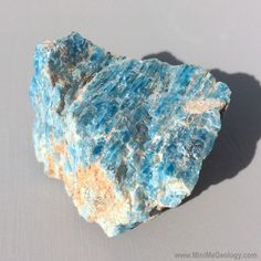 a piece of blue and yellow rock sitting on top of a table