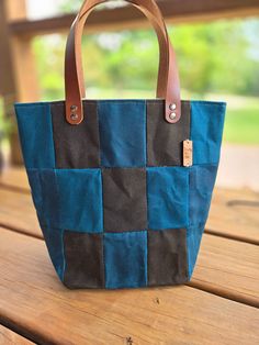 These beautiful handmade bags are made from waxed canvas sewn into fun patchwork deisgns. Each bag is a unique one-of-a-kind combination, picked and hand-sewn by me!  They can be used for your knitting, crochet, embroidery, or any projects, carry your books, or even use it as a purse. They are designed to stand up so you can work directly from them.  Each bag is handmade with beautiful, high-quality waxed canvas fabric on the exterior, a heavy canvas lining, and sturdy leather handles.  Size: ap Rectangular Cotton Bag With Waxed Finish, Rectangular Cotton Bags With Waxed Finish, Rectangular Cotton Shoulder Bag With Waxed Finish, Black Patchwork Shoulder Bag For Everyday Use, Everyday Upcycled Cotton Canvas Bag, Canvas Patchwork Shoulder Bag For Daily Use, Canvas Patchwork Bags For Everyday Use, Upcycled Everyday Canvas Bag, Upcycled Canvas Bag For Everyday Use