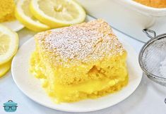 a close up of a plate of food with lemons on the table behind it